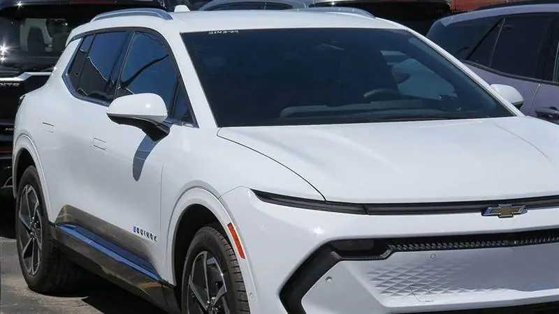 White Chevrolet Equinox EV compact electric SUV photographed from the front showing its Chevrolet badge