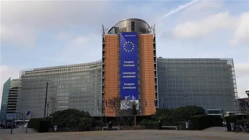The Berlaymont building, headquarters of the European Commission in Brussels, with a large European Commission banner and EU stars on its facade