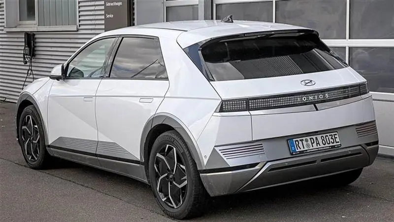 Rear three-quarter view of a silver Hyundai Ioniq 5 electric crossover on a street.