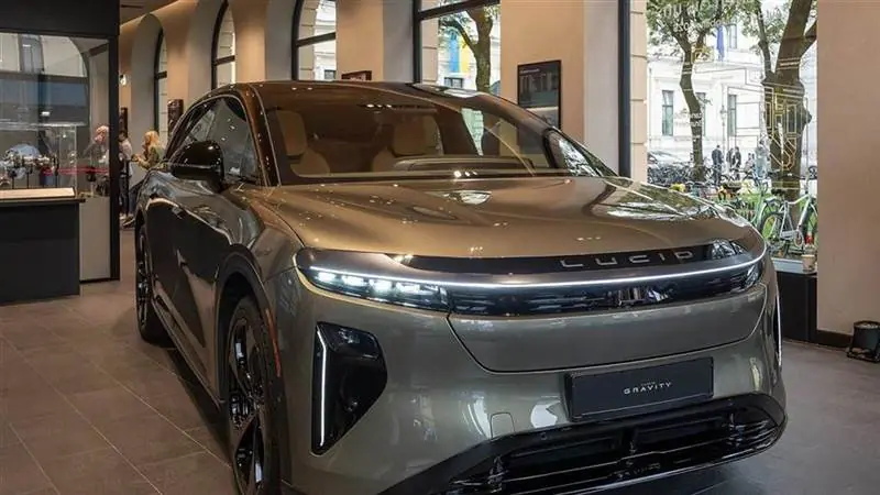 An Aurora Green Metallic Lucid Gravity Grand Touring electric SUV on display at the Lucid Studio in Munich
