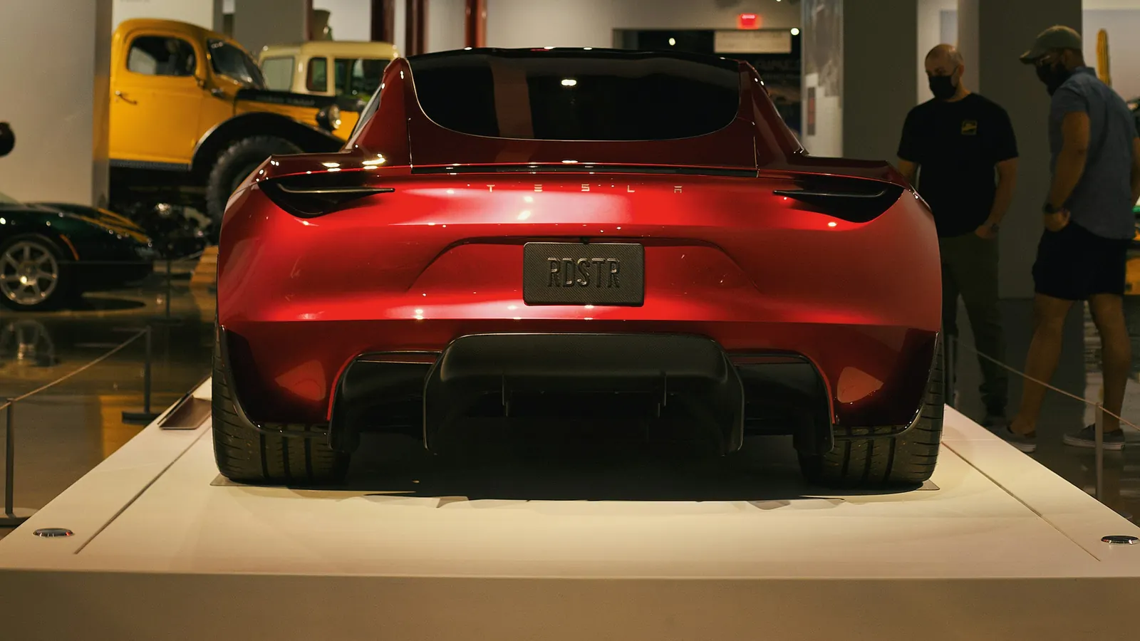 Rear view of a red 2020-design Tesla Roadster prototype displayed at the Petersen Automotive Museum; this archival photo does not show the redesigned 2026 car.