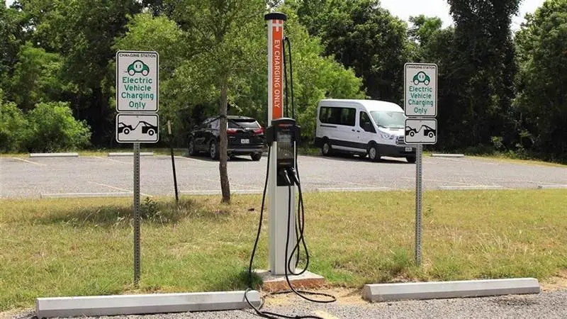 An electric vehicle plugged into a public charging station in Austin, Texas