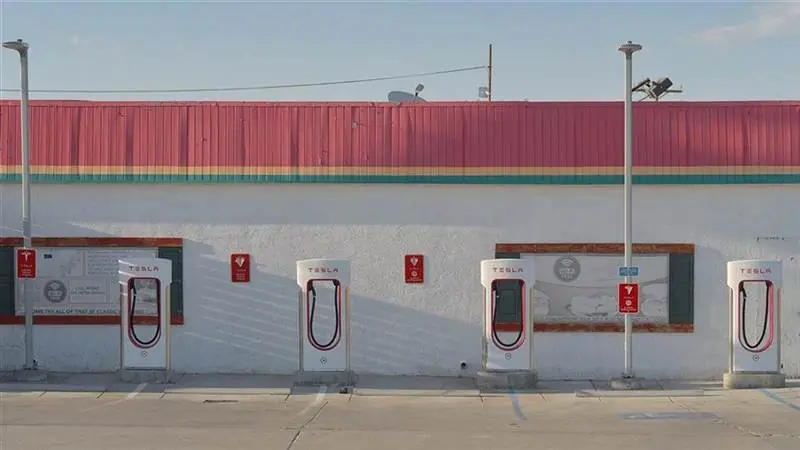 A row of Tesla Supercharger stalls at a charging station in Inyokern, California